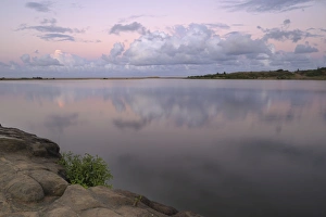 Reflected clouds in shoreline estuary system with embankment in foreground, St Lucia Reflected clouds in shoreline estuary system with embankment in foreground, St Lucia
