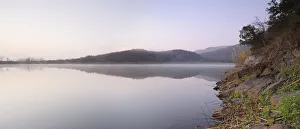 Reflection of hills in still lake water with shore in foreground, Pongola, Kwazulu-Natal Reflection of hills in still lake water with shore in foreground, Pongola, Kwazulu-Natal