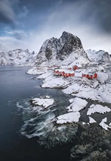 Rorbuer fishermen's cabins on the snowy fjord, village view of the fishing village Hamnoy Rorbuer fishermen's cabins on the snowy fjord, village view of the fishing village Hamnoy