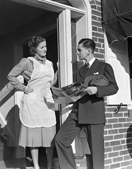 Salesman At Door Of A House Wife Showing Her A Bro Salesman At Door Of A House Wife Showing Her A Bro