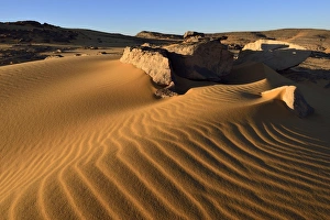Sand dunes and sandblasted rocks on Tadrart plateau, Tassili nAjjer National Park Sand dunes and sandblasted rocks on Tadrart plateau, Tassili nAjjer National Park
