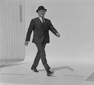 Senior man walking in full suit, portrait, smiling Senior man walking in full suit, portrait, smiling