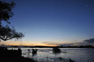 Serene view overlooking The Victoria Falls in Zambia at sunset Serene view overlooking The Victoria Falls in Zambia at sunset