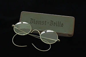 Service glasses from 1938 with a sheet metal case on black Service glasses from 1938 with a sheet metal case on black