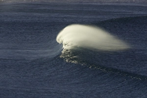 Single wave rushing toward beach, Australia Single wave rushing toward beach, Australia