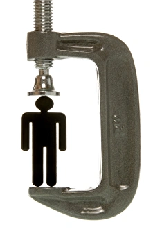 Small black female figurine in a screw clamp, symbolic image for being under pressure to Small black female figurine in a screw clamp, symbolic image for being under pressure to