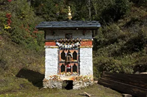 Small shelter for a Buddhist prayer wheel at the entrance to Dochula Pass, Bhutan, South Asia Small shelter for a Buddhist prayer wheel at the entrance to Dochula Pass, Bhutan, South Asia