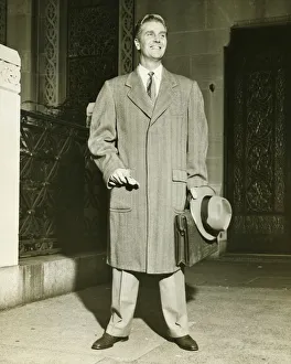 Smiling man in top coat standing outdoors, (B&W) Smiling man in top coat standing outdoors, (B&W)
