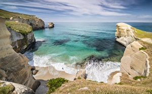 Solitary person on the rocky cliffs of the Pacific coast in the distance Solitary person on the rocky cliffs of the Pacific coast in the distance