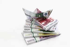 Stacked euro notes in bundles with boat made from notes Stacked euro notes in bundles with boat made from notes
