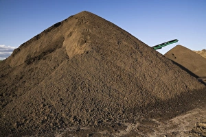 Stacking conveyor and mounds of sand in a commercial sandpit, Quebec, Canada Stacking conveyor and mounds of sand in a commercial sandpit, Quebec, Canada