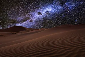 Starry night over the dunes in the desert Starry night over the dunes in the desert