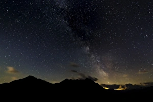 Starry sky with the Milky Way over a mountain landscape, with light pollution, Safien Starry sky with the Milky Way over a mountain landscape, with light pollution, Safien