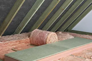 Storage decking on top of fiberglass roof insulating material in attic Storage decking on top of fiberglass roof insulating material in attic