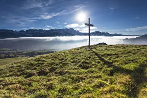Summit cross of Gerenberg Mountain with high fog in front of the Alpstein Mountains Summit cross of Gerenberg Mountain with high fog in front of the Alpstein Mountains