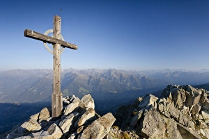 Summit cross on Ifinger Mountain above Merano with a view into the Passaiertal Valley Summit cross on Ifinger Mountain above Merano with a view into the Passaiertal Valley