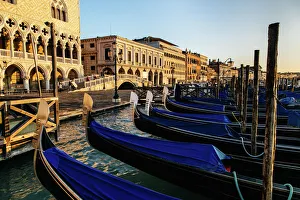 Sunrise view on gondola station near Piazza San Marco with Palazzo Ducale (Doges Palace) on a background Sunrise view on gondola station near Piazza San Marco with Palazzo Ducale (Doges Palace) on a background