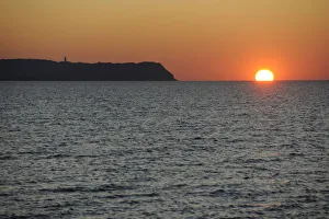 Sunset over the Baltic Sea beside Hiddensee Island with Dornbusch lighthouse, Hiddensee Sunset over the Baltic Sea beside Hiddensee Island with Dornbusch lighthouse, Hiddensee