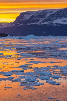 Sunset above icebergs and brash ice, Gasefjord, Scoresby Sund, Greenland, Denmark Sunset above icebergs and brash ice, Gasefjord, Scoresby Sund, Greenland, Denmark