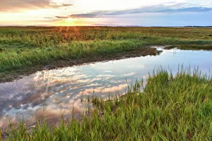 Sunset over tidal marsh at Massachusetts Audubons Wellfleet Bay Wildlife Sanctuary Sunset over tidal marsh at Massachusetts Audubons Wellfleet Bay Wildlife Sanctuary
