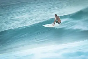 Prints of Male surfer in early 30s rides wave at Hookipa, Maui, Hawaii, image shows motion blur of surfer riding wave Images Dated 2011 October: Surfer in Motion Print: Hookipa, Maui, Hawaii