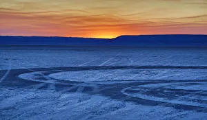 Tire tracks on Alvord Desert at sunrise, Oregon, USA Tire tracks on Alvord Desert at sunrise, Oregon, USA
