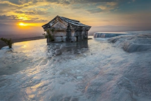 Tomb submerged in a travertine pool in Hierapolis at sunset Tomb submerged in a travertine pool in Hierapolis at sunset