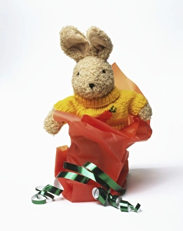 Toy rabbit with wrapping paper and ribbons Toy rabbit with wrapping paper and ribbons