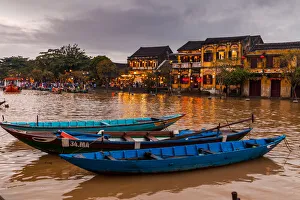 Traditional boats in front of ancient architecture in Hoi An, Vietnam Traditional boats in front of ancient architecture in Hoi An, Vietnam