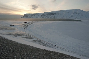 Trapper huts at Cape Schoulz at sunset on the partially frozen Tempelfjorden, Spitsbergen Trapper huts at Cape Schoulz at sunset on the partially frozen Tempelfjorden, Spitsbergen