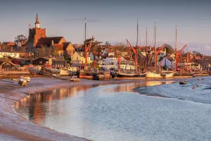 Prints of Maldon, Essex, UK. April 11 2021. The Blackwater Estuary at Maldon in Essex at low tide early one Spring morning. Moored up in the distance are a number of Thames barges, used for sailing trips Essex Prints: Maldon View Print: Blackwater Estuary at Low Tide, Essex