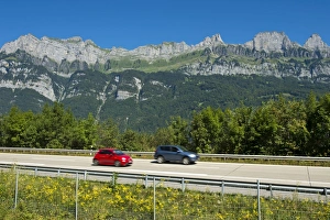 Vehicles on the A3 motorway in front of the Churfirsten range near Lake Walen Vehicles on the A3 motorway in front of the Churfirsten range near Lake Walen