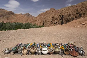 Vendor displays souvenirs and trinkets on blanket alongside road, Dades Gorge, Morocco Vendor displays souvenirs and trinkets on blanket alongside road, Dades Gorge, Morocco