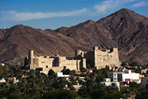 A view of Bahla Fort with the Hajar Mountains in the background. Northern Oman A view of Bahla Fort with the Hajar Mountains in the background. Northern Oman