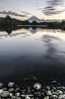 View over a lake towards Mt. Egmont, Mt. Taranaki, currently an inactive volcano View over a lake towards Mt. Egmont, Mt. Taranaki, currently an inactive volcano
