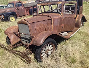 Vintage vehicles left to rot in a prairie scrapyard Vintage vehicles left to rot in a prairie scrapyard