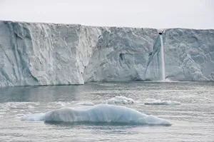 Waterfall of meltwater at the glacier front of Brasvellbreen Waterfall of meltwater at the glacier front of Brasvellbreen