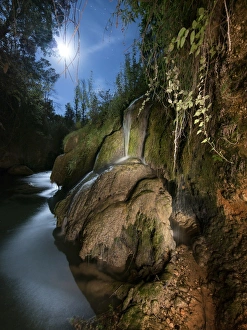 Waterfall in a ravine in the moonlight fills Waterfall in a ravine in the moonlight fills