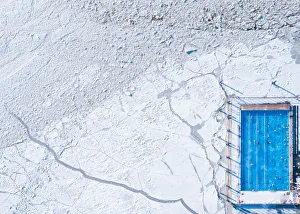 Wintery top-down aerial view of a heated swimming pool next to frozen Baltic sea Wintery top-down aerial view of a heated swimming pool next to frozen Baltic sea