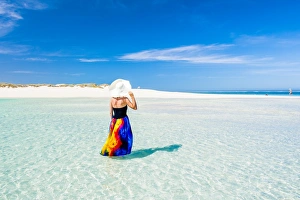 Woman with colorful dress standing on the turquoise water. Western Australia Woman with colorful dress standing on the turquoise water. Western Australia