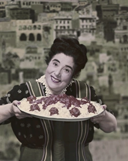 Woman holding prepared fettuccine with meatballs Woman holding prepared fettuccine with meatballs