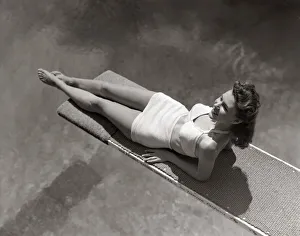 Woman Lying On Diving Board Over Pool Sunbathing Two Piece Bathing Suit Summer Woman Lying On Diving Board Over Pool Sunbathing Two Piece Bathing Suit Summer