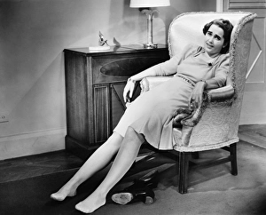 Woman reclining in armchair, exhausted, (B&W) Woman reclining in armchair, exhausted, (B&W)
