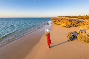 Woman with red dress on Osprey Bay beach at sunset. Western Australia Woman with red dress on Osprey Bay beach at sunset. Western Australia