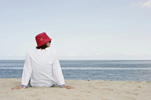 Woman with red hat on the beach, List, Sylt island, Schleswig-Holstein, Germany, Europe Woman with red hat on the beach, List, Sylt island, Schleswig-Holstein, Germany, Europe