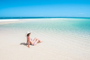 Woman relaxing on the beach. Turquoise Bay, Western Australia Woman relaxing on the beach. Turquoise Bay, Western Australia