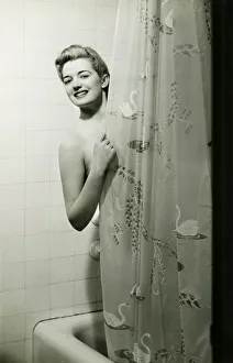 Woman standing in bathtub, peering through shower curtain, (B&W), portrait Woman standing in bathtub, peering through shower curtain, (B&W), portrait