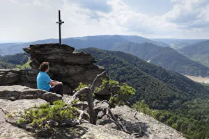 Woman at the summit cross, Hoher Stein Mountain, Muehlberg, Dunkelsteinerwald, Wachau Woman at the summit cross, Hoher Stein Mountain, Muehlberg, Dunkelsteinerwald, Wachau
