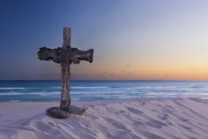 Wooden cross on a beach at sunset - De Mond, South Africa Wooden cross on a beach at sunset - De Mond, South Africa