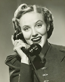 Young woman using phone, smiling, (B&W), portrait Young woman using phone, smiling, (B&W), portrait